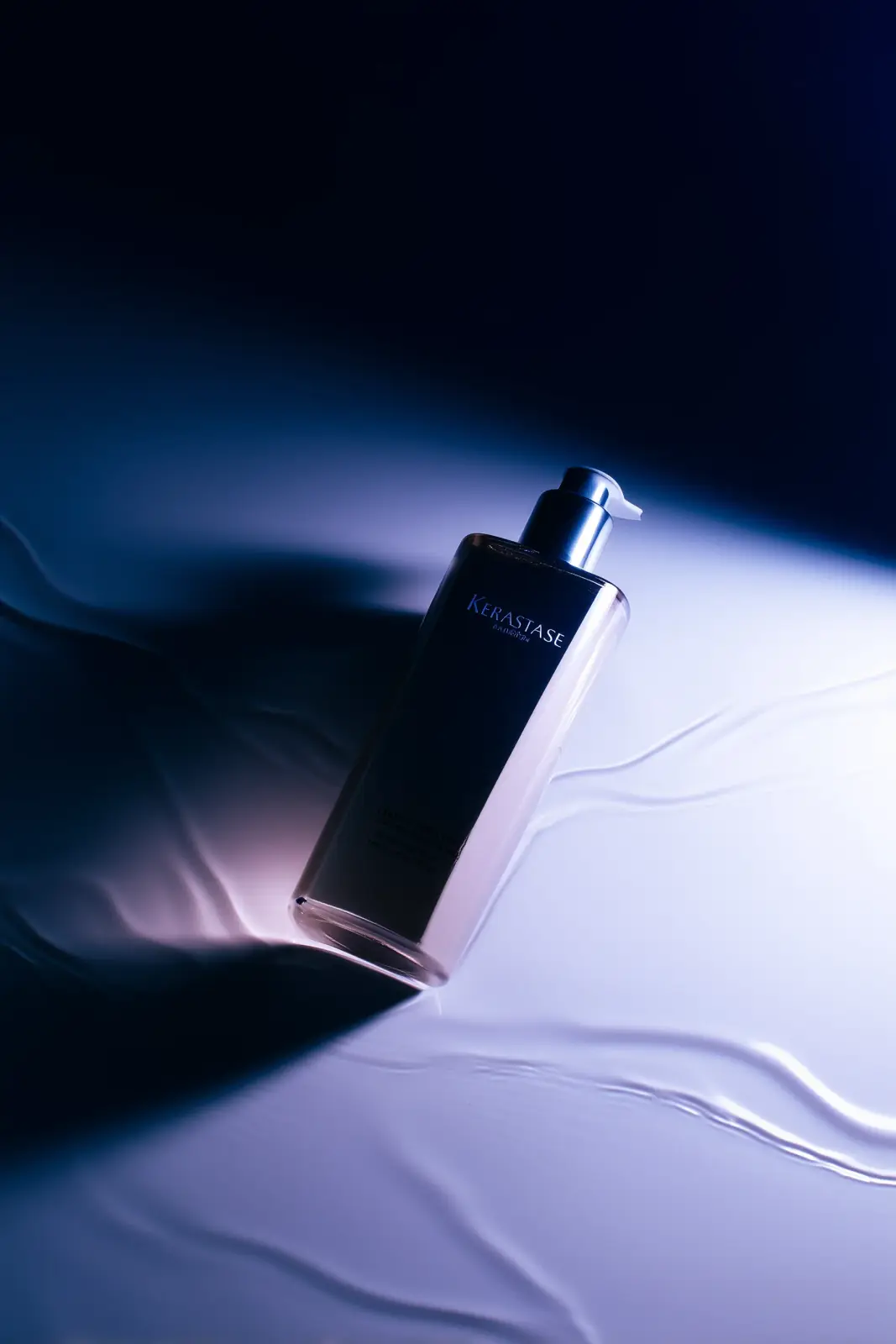 Luxury perfume bottle in blue light